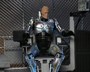 RoboCop Figura Ultimate Battle Damaged RoboCop with Chair